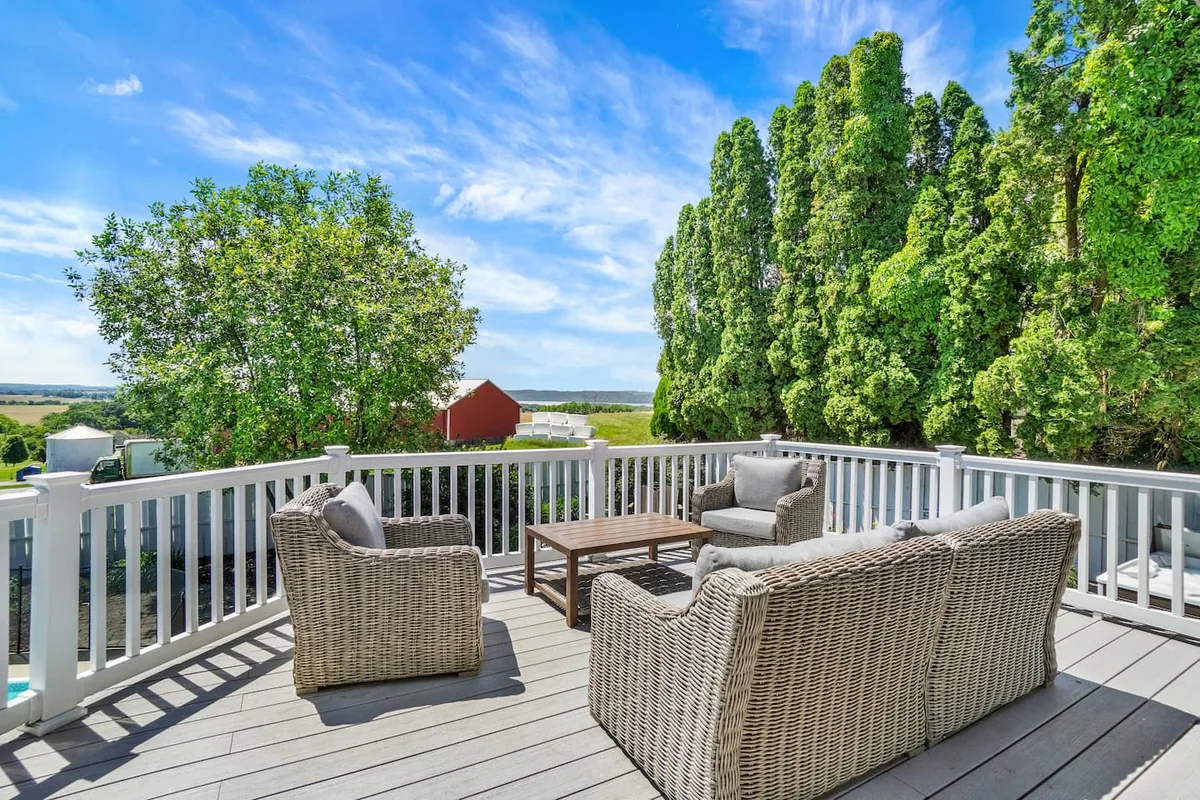 Deck seating with farmland views at Lancaster Retreat