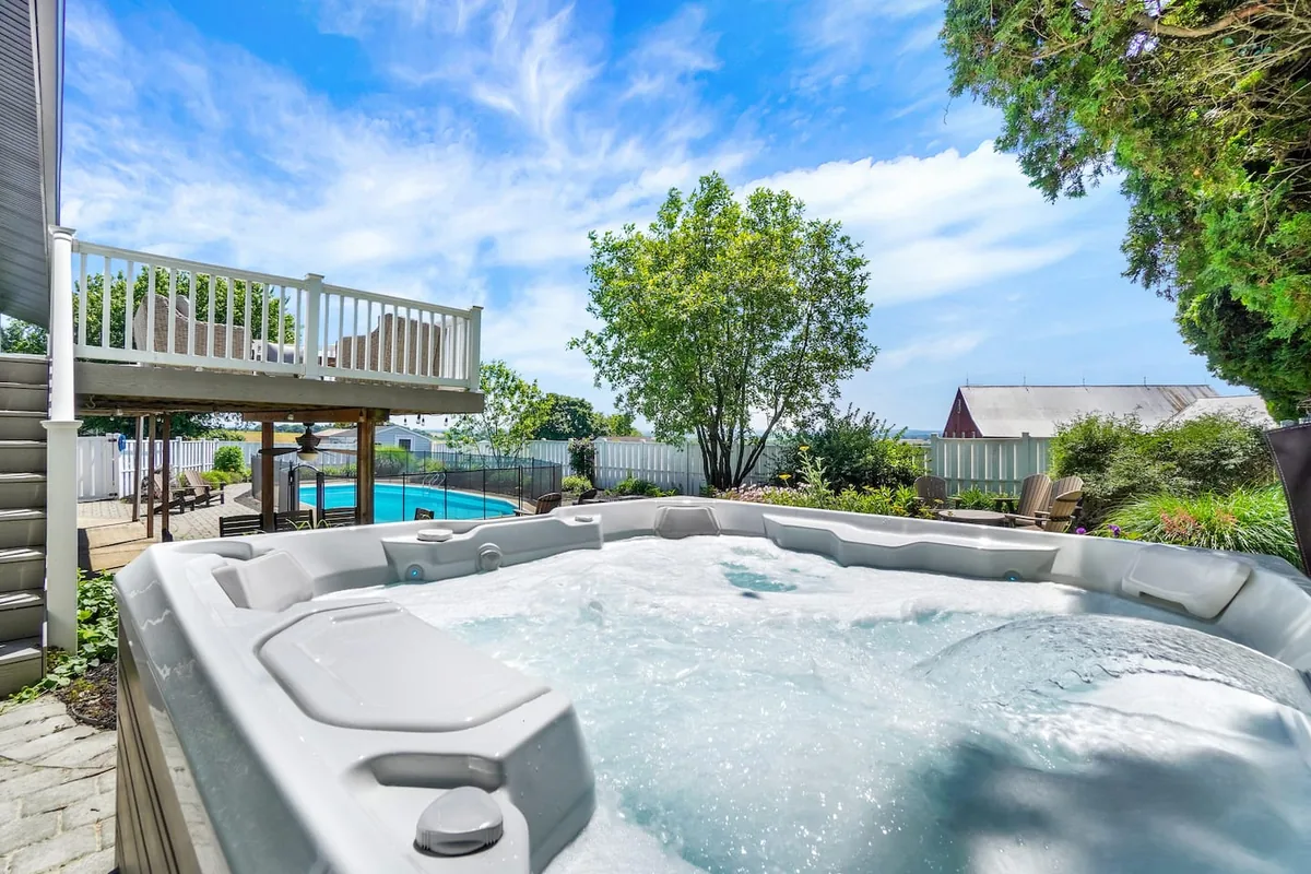 Hot tub beside the pool at Lancaster Retreat