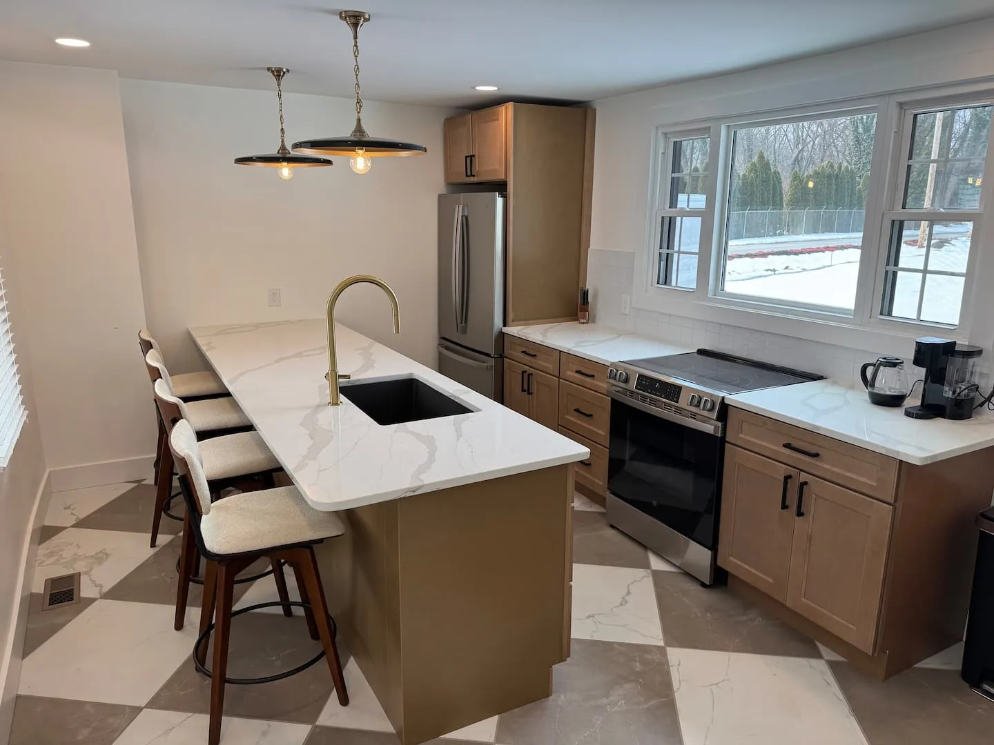 Kitchen with marble island and brass fixtures at the Marietta Bike House